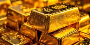 A stack of gleaming gold bullion bars, representing a safe-haven asset in a low-rate environment.